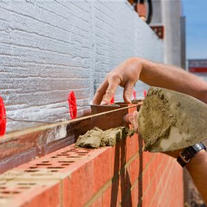close-up-of-bricklayer-laying-brick-wall-on-constr-2026-03-26-04-41-20-utc