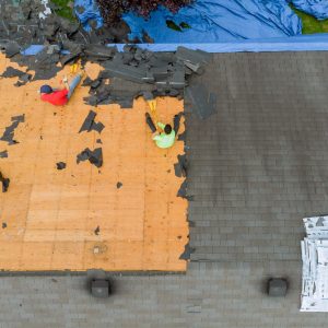 Removal of old roof replacement with new shingles of an apartment building