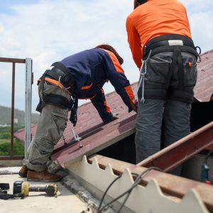 Professional engineer worker installing solar panels system on rooftop